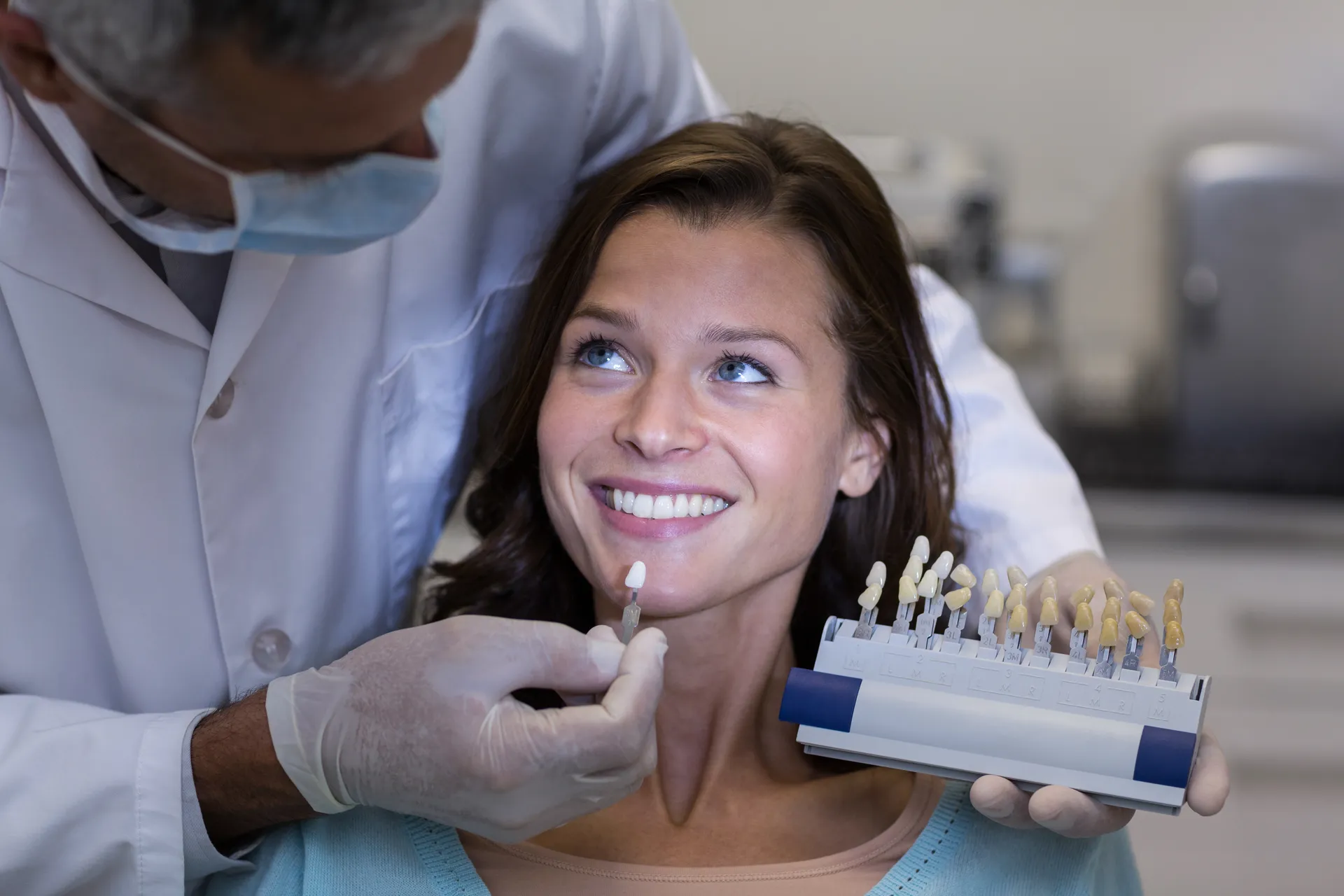 dentist-examining-female-patient-with-teeth-shades-2023-11-27-04-57-46-utc